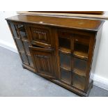 Display cabinet: 20th Century oak linen fold low standing display cabinet