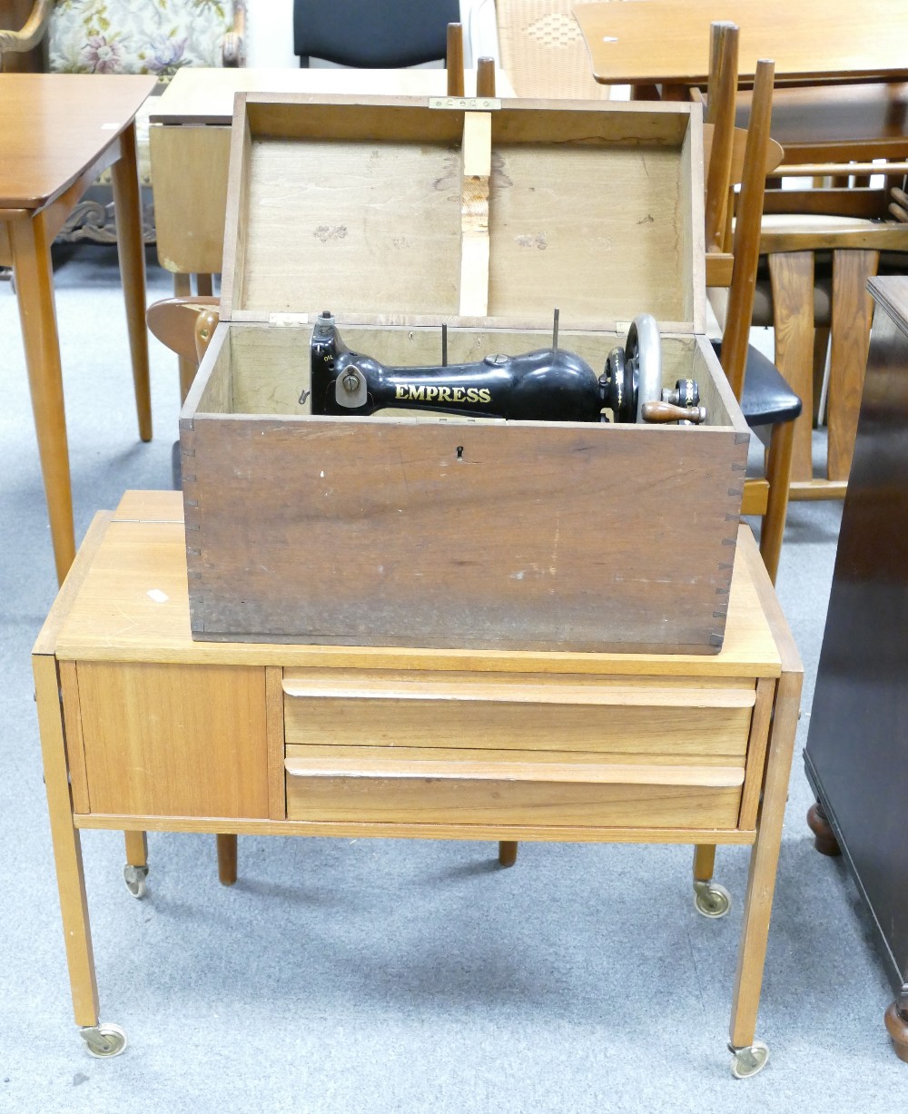 Sewing items: Mid century teak sewing cabinet, together with earlier boxed empress sewing machine.