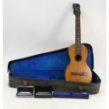 Early 20th Century cased ukulele: together with 4 boxed harmonicas