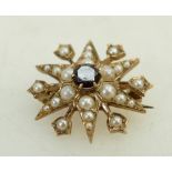 9ct star brooch: set with garnet and sead pearls, 4.7grams, in leather box.