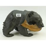 Large black forest type carved wooden bear: Bear carrying a fish.