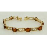 Yellow coloured metal gold bracelet: Bracelet set with Topaz or similar stone,