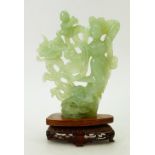 Chinese carved Jade figure: Figure on carved wooden stand. Standing 23.5cm high inc. base.