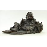 19th century Chinese Buddha figure Liu Hai lying with mythical beast: Split noted from foot of base