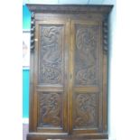 19th century dark Oak two door Wardrobe: Both wardrobe doors carved with flowers,