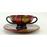 William Moorcroft unusual Flambé soup cup and saucer: A two handled cup & saucer decorated in the