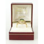 18ct gold Diamond ring: Ring set with centre dark and light precious stones surrounded by diamonds,