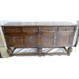 Early 20th century dark oak Sideboard: Sideboard with four doors & drawers, heavily carved,