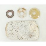 A collection of early Chinese items: Chinese early axe head, set of three agate rings, bi disc etc.