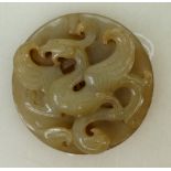 A Chinese Jade Exotic bird pendant: Pendant diameter 6 cm Provenance Collection of Richard Drew