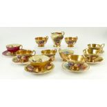 A collection of Aynsley gilded tea cups and saucers: Aynsley cups and saucers decorated with