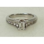 Platinum diamond ring: Ring set with a baguette diamond with smaller diamonds set in the shank,