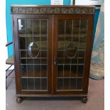 20th century Oak glazed Bookcase / Display cabinet on bun feet.