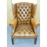 Chesterfield Wingback Armchair: Upholstered in Chestnut brown leather.