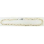 String of cultured pearls: Single strand pearls with white metal & diamond clasp.