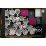 A mixed collection of items to include: commemorative mugs, boxed similar items,