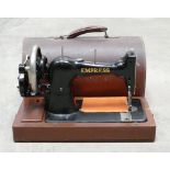 Cased Empress branded hand crank table top sewing machine: