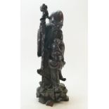 19th Century Chinese Carved & Silver Inlaid Wooden Figure: Depicting an Immortal leaning on a