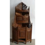 Burmese carved Teak Corner unit: Repaired carving noted to top edging and figures missing to