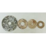 A collection of four Chinese Bi discs: Two calcified Bi discs with slight risen inner rim,