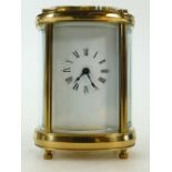 Small brass oval cased Carriage Clock: Carriage clock timepiece of small size with oval case,