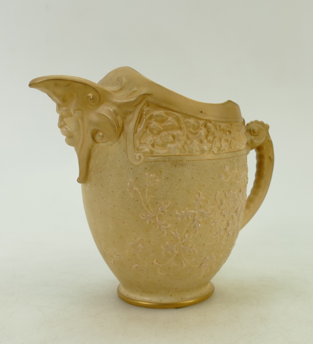 Doulton Burslem Jug: Doulton Burslem ewer decorated all around with flowers and mask head to spout,