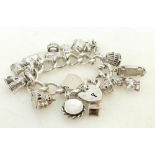 Silver Charm Bracelet: Silver charm bracelet with 15 good quality silver charms,123.4 grams.