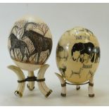 Decorative Ostrich eggs on stands: Emu egg decorated with Antelope and signed Sibs AW on boar tusk
