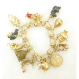 18ct gold Charm Bracelet: 18ct gold charm bracelet with 12 good quality charms including 1 x 14ct