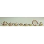 Coalport hand painted miniatures with encrusted flowers: Floral Design with gilt highlights.