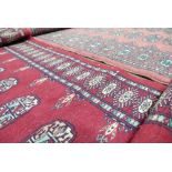Oriental Hand Made Rugs in the Bokhara Design: A pair of rugs 183cm x 65cm and 156cm by 68cm with
