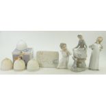 A group of Lladro Figurines to include: Maid with Bunny and Cherub playing flute,