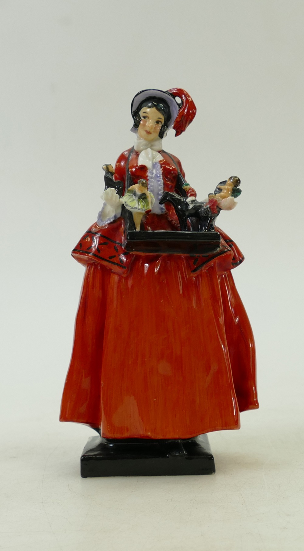 Royal Doulton figure The Sketch Girl: A Victorian street seller with tray of dolls and toys,