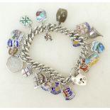 Silver Charm Bracelet: Silver charm bracelet with 19 silver charms, 56.2 grams.