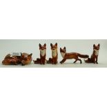 A group of Beswick foxes to include a curled fox 10147: Small standing fox 1418 and three seated