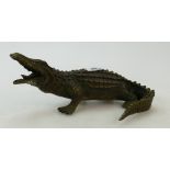 A bronze sculpture of a crocodile:A bronze sculpture of a crocodile