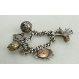 Silver vintage charm bracelet: Silver Albert chain mounted with various silver charms medals etc,