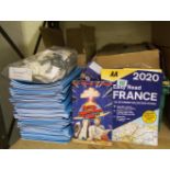 A quantity of staitionary items to include: notebooks, comic books, AA France atlases, plastic