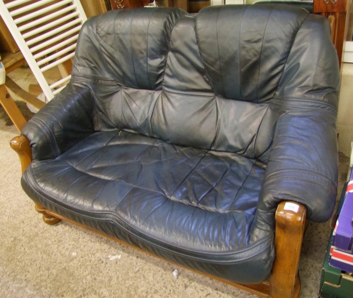 A two seater oak framed blue leather sofa: