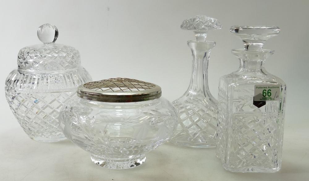 A collection of quality cut glass crystal items to include: decanters, lidded vase and flower