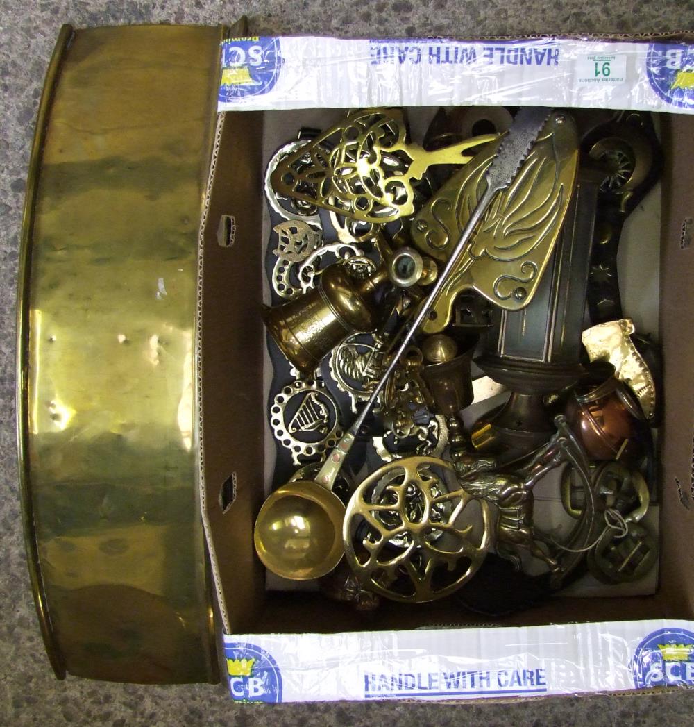 A collection of brass items to include: brass fender, horse brasses, oriments, stands etc