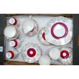 A Winston red and gold part tea set: to include 6 cups and saucers, 6 side plates, 1 cake plate