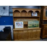 Stripped pine dresser with panelled rack, kennels & 6 mini drawers above cupboards & 3 waist drawers