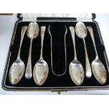 A set of six similar teaspoons and a pair of sugar tongs in a fitted case