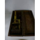 A Victorian brass and cast iron microscope in oak case