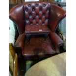 Red leather studded & buttoned wing back arm chair & matching footstool