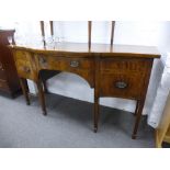 An antique mahogany serpentine sideboard with crossbanded decoration on square moulded legs 167cms