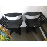 A pair of modern black stained beech folding chairs on throne style