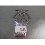 A 1912 chrome AA car badge numbered 2219E. 12cm high