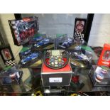 8 Cased 'Heritage racing' Formula 1 cars including F1 stering wheel model miniature helmets and